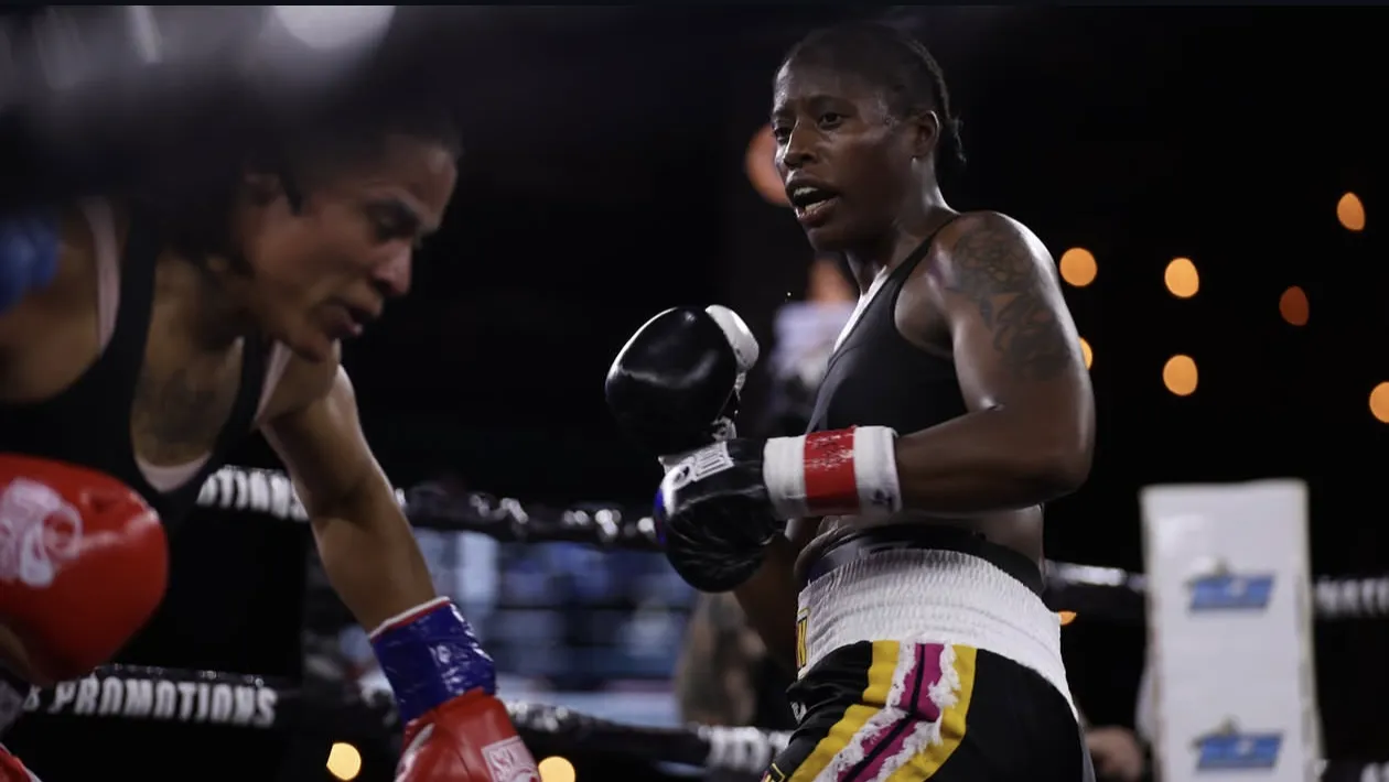 Fisher, right, sets her guard as Cotton crouches forward inside the ropes during their bout.