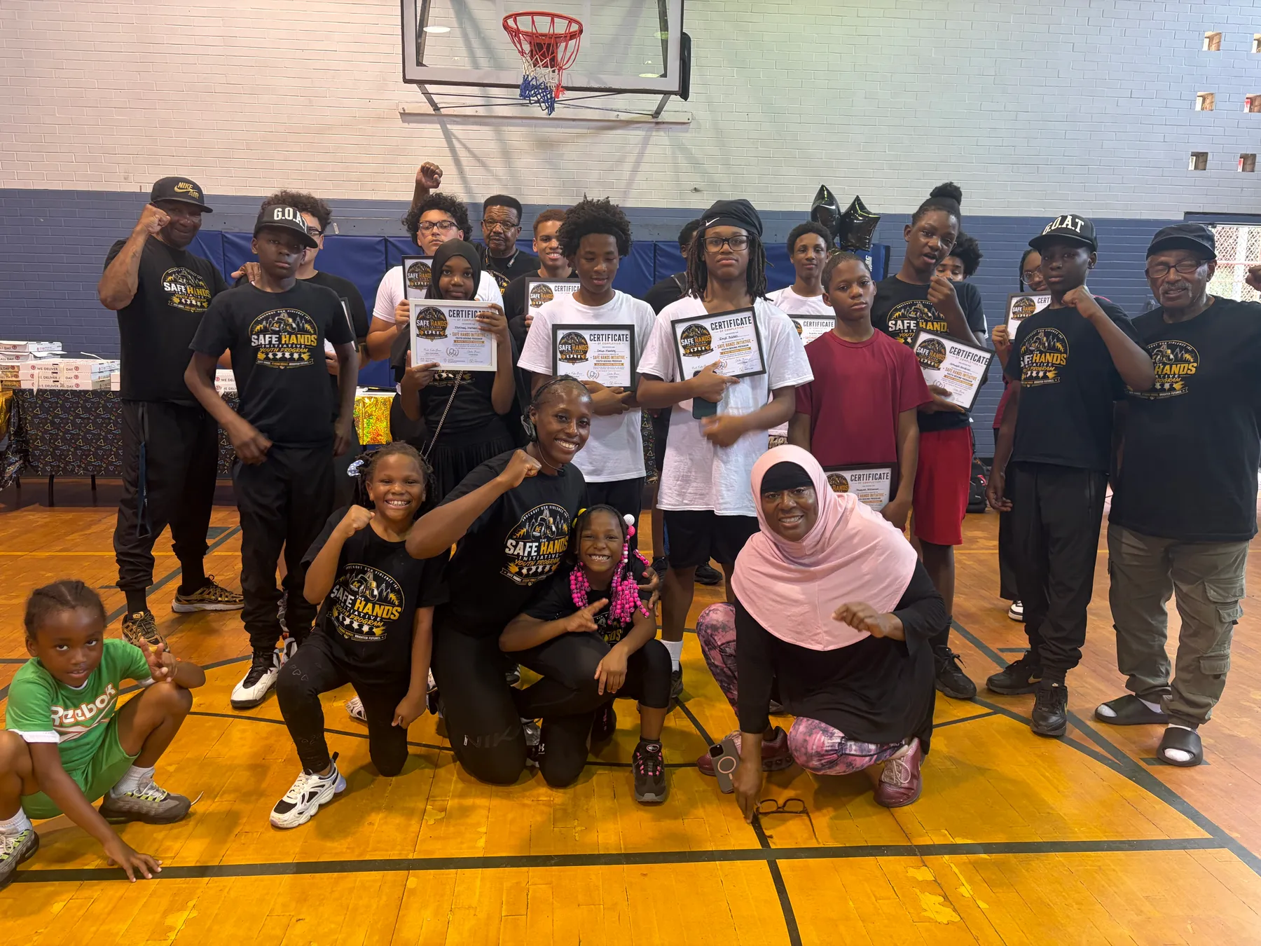 The full Safe Hands Initiative youth boxing group with coaches and certificates.